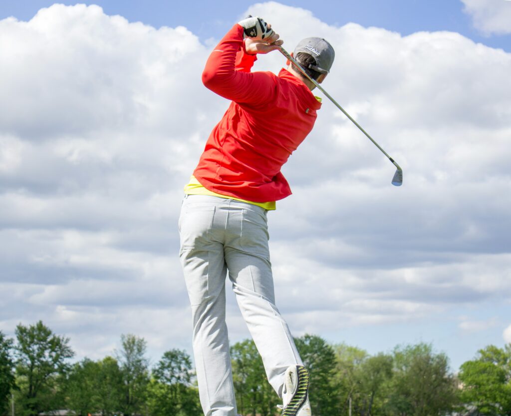 A photo of a man playing golf.