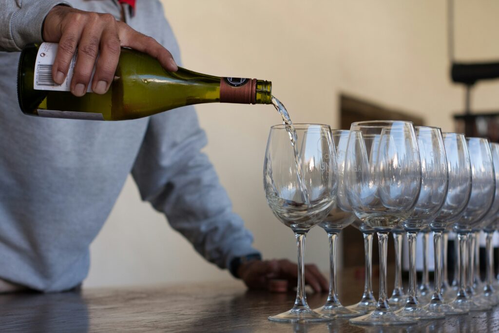 Someone pouring wine for a wine tasting at a Rhode Island winery. 