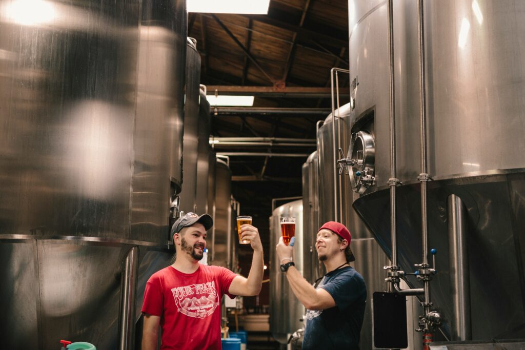 Brewers sampling their beer near the fermentation tanks in Rhode Island. 