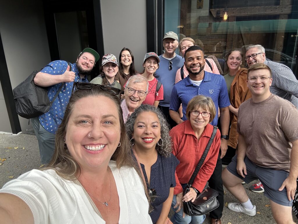 A group from a food tour gets together to take a group selfie in Providence, Rhode Island.  